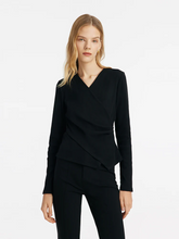 a lady in a black v-neck crossover gathered waist knit top